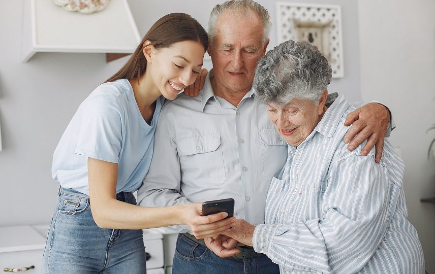 Old couple in a kitchen with young granddaughter