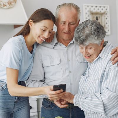 Old couple in a kitchen with young granddaughter