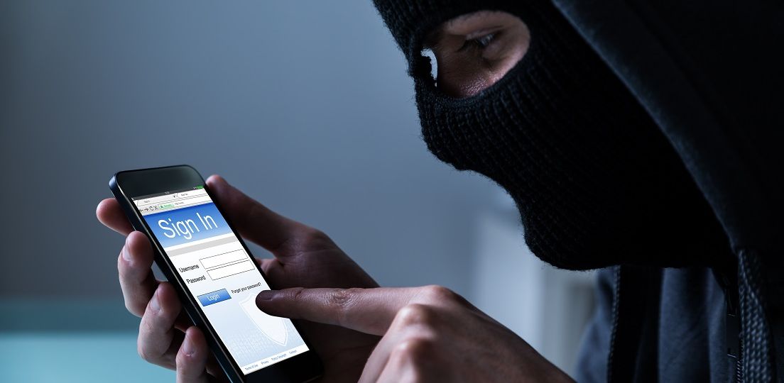 Close-up,Of,Hacker,Using,Smart,Phone,To,Steal,Data,In