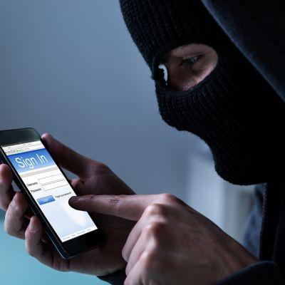 Close-up,Of,Hacker,Using,Smart,Phone,To,Steal,Data,In